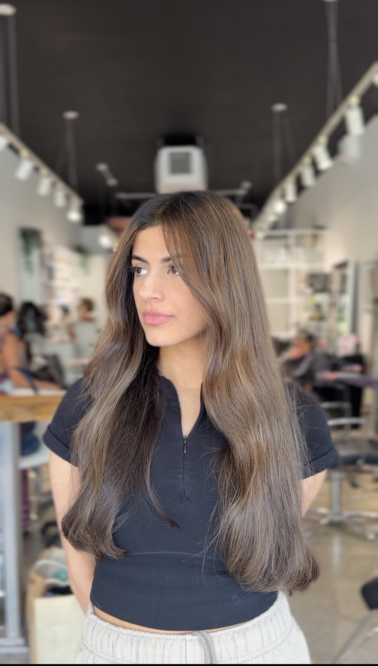 Long glossy dimensional brunette color by Jasmine Reyes